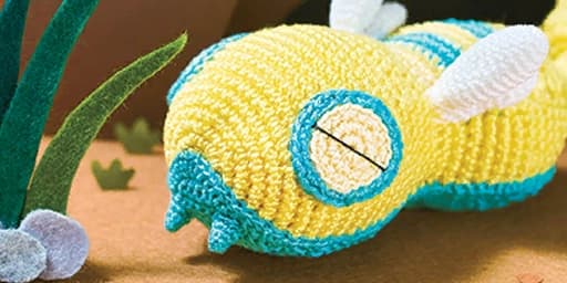 A handmade sleeping Pokémon sculpture with a soft craft style
